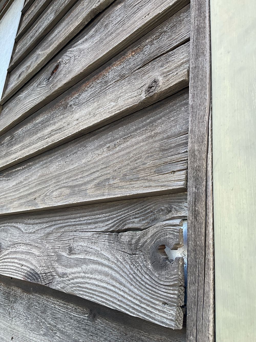 Damaged cladding that will deteriorate further in the weather, found during a building and pest inspection in Newport