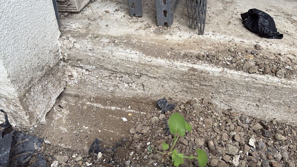 Localised voids in slab edge concrete awaiting the engineer's repair method, found during a defect investigation in Herne Hill